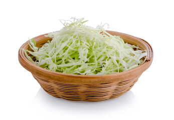 Green sliced cabbage in wooden basket isolated on white background