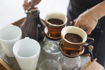Alternative manual hand coffee brewing in origami dripper with paper filter.