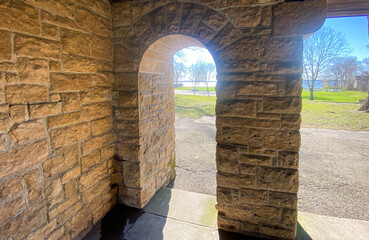 old stone pavilion in park arched doorway