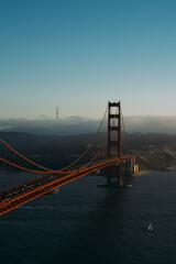 golden gate bridge at sunset above the clouds