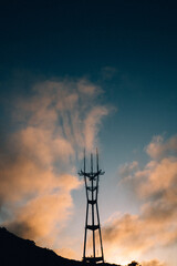 high voltage tower at sunset, sutro tower in the clouds