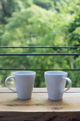 Coffee cup on wooden table in coffee shop.
