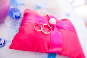 Bride and groom hands exchanging wedding rings close up during symbolic nautical decor destination wedding marriage on sandy beach in front of the ocean in Punta Cana, Dominican republic  