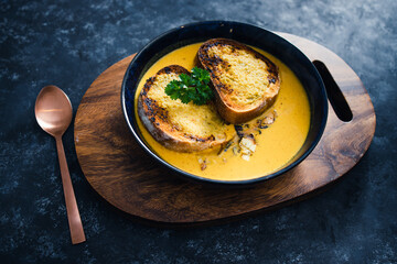 plant-based food, vegan pumpkin soup with garlic bread and coriander