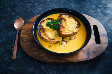 plant-based food, vegan pumpkin soup with garlic bread and coriander