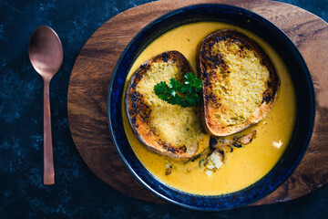 plant-based food, vegan pumpkin soup with garlic bread and coriander