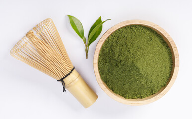 Matcha green tea powder in bowl with Organic green tea leaf and Japanese wire whisk isolated on white background, Organic product from the nature for healthy with traditional style