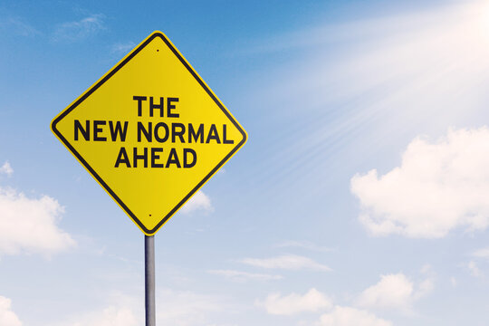 Street sign with text of The New Normal Ahead