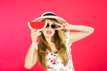 Attractive young woman posing with watermelon
