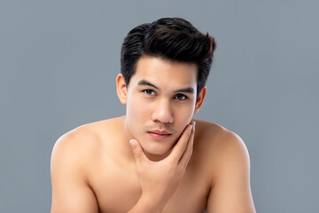 Fototapeta na wymiar Portrait of shirtless young handsome Asian man for skincare and beauty concepts against gray studio background