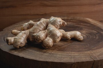 fresh ginger on wooden stump background