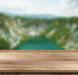 Wood table top on a blur nature background.
