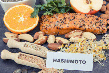 Inscription hashimoto with products and ingredients containing vitamins for healthy thyroid