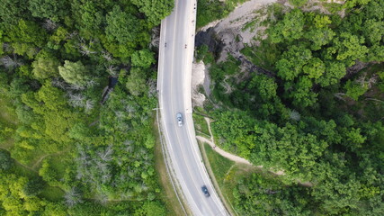 Aerial Image of a Road through a forest surrounded by trees