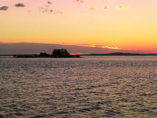 Sunset over ocean with Island in view