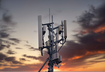 Telecommunication tower 4G and 5G. Macro Base Station or Base Transceiver Station. Wireless Communication Antenna Transmitter. Development of communication systems in urban area at sunset.