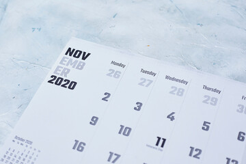 Simple 2020 November monthly calendar on table with office supplies