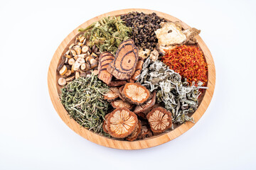 Chinese herbal medicine for soaking feet in a saucer on white background