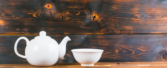 tea bowl and pot on rustic wooden table, panoramic shot