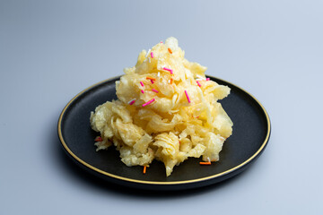 Chinese traditional Beijing snack with pastry fried with ginger juice and sugar. Old Beijing ginger sauce fork. Old Beijing snack fork. 