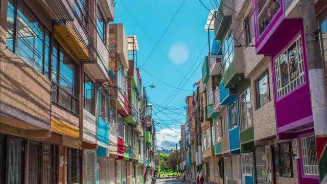 timelapse of set of colorful houses in the city of bogota, clear blue sky, people transit part 2 clean sky