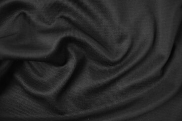Background texture black cloth. Abstract dark wavy soft. Fabric is wrinkled. Fashion luxury style.