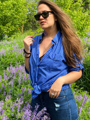 photo of a young girl in a summer field in flowers