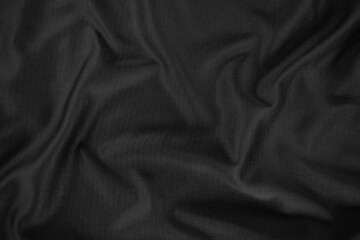 Background texture black cloth. Abstract dark wavy soft. Fabric is wrinkled. Fashion luxury style.