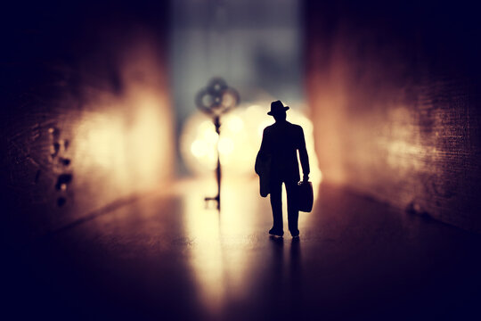 Concept Image Of Person Walking Towards Bright Light And Finding The Right Key In Dark Path