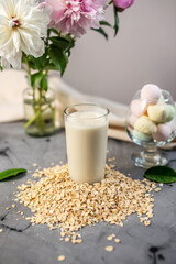 Vegetable natural oat milk on the table. Alternative vegetarian drink for a healthy diet
