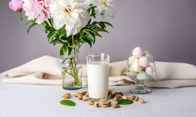 Natural vegetable almond milk on the table. Nutty alternative vegetarian drink for a healthy diet