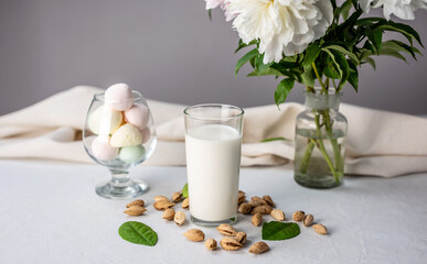Natural vegetable almond milk on the table. Nutty alternative vegetarian drink for a healthy diet