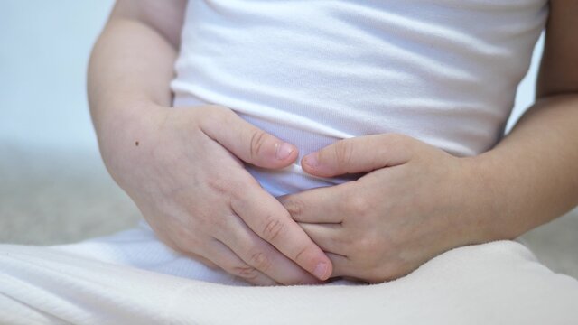 A Small Child Experiences Abdominal Pain. Kid Holds His Hands On His Stomach. Digestive Tract Poisoning. Appendicitis