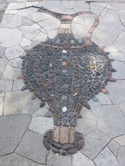 Mosaic on the sidewalk in a large piccher vintage