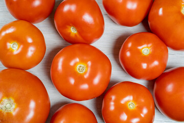 Tomatoes on bleached wood. Background on the theme of tomatoes.