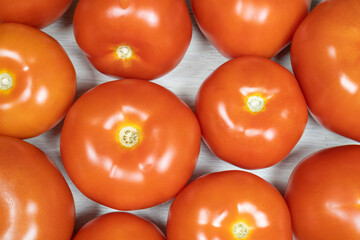 Tomatoes on bleached wood. Background on the theme of tomatoes.