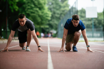 Athlete men in sportswear in the start position for running. Close up.