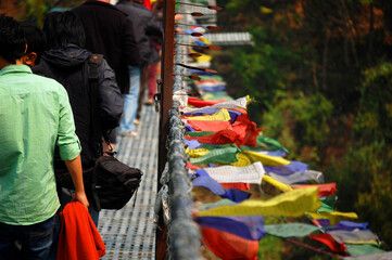 buddhist prayer flags on bridge