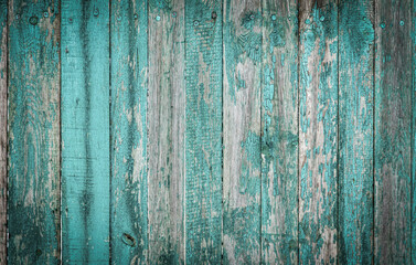 Wooden boards on an old blue fence as an abstract background.