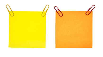 Colored pieces of paper with paper clips on a white background.