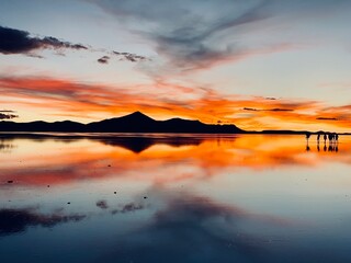 Red stunning sunset over the saline salt flats in Salar de Uyuni, Bolivia. Unforgettable view. 