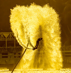 Water spray from flyboard to the sea.