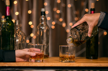 Barman pouring whiskey whiskey glass beautiful night