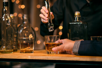 Waitress pouring whiskey glass customers sit drink
