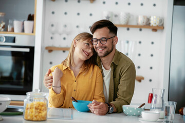 Young couple eating breakfast at home. Loving couple enjoying in morning..	