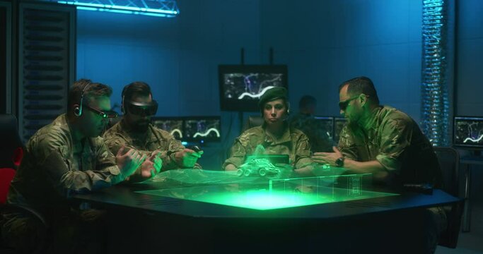 Soldiers remote controlling unmanned ground vehicle