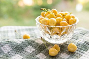Yellow cherries in a crystal vase, summer summer harvest of berries