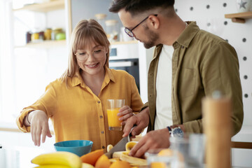 Young couple eating breakfast at home. Loving couple enjoying in morning..	