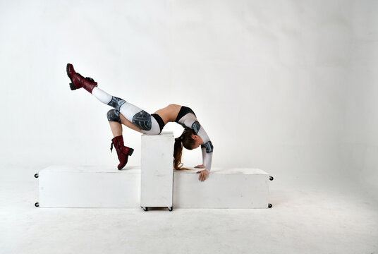 beautiful girl in the image of a robot does gymnastic exercises