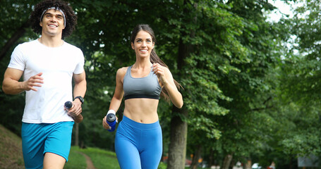 Couple jogging and running outdoors in nature